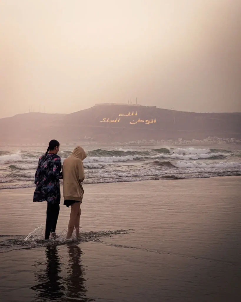 Evening walk on Agadir beach with the Oufella hill in the background