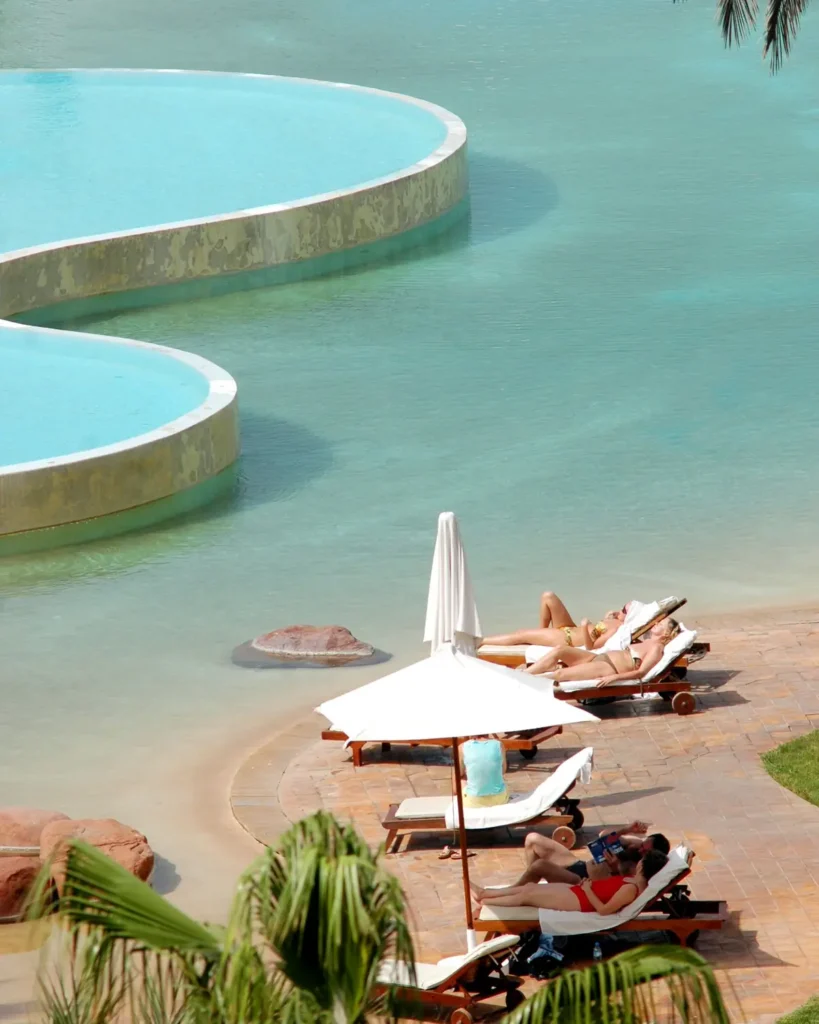 Guests sunbathing by a resort pool in Agadir