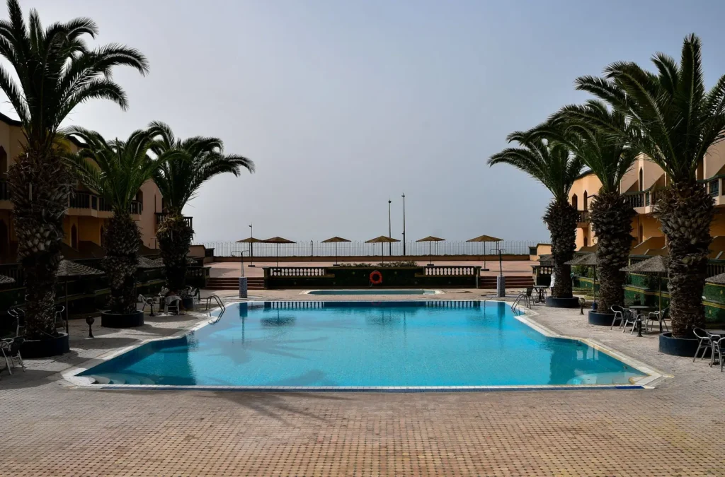 Seaside hotel pool with palm trees in Morocco