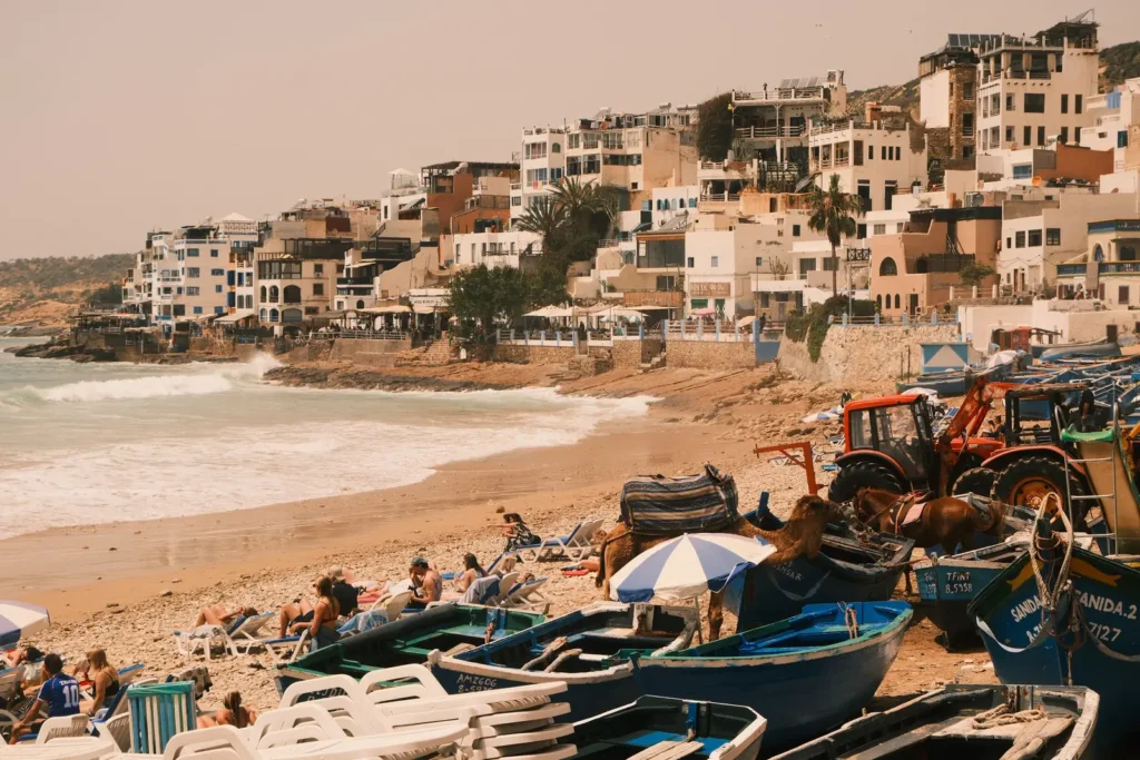 Taghazout beach with fishing boats and the village on the hillside