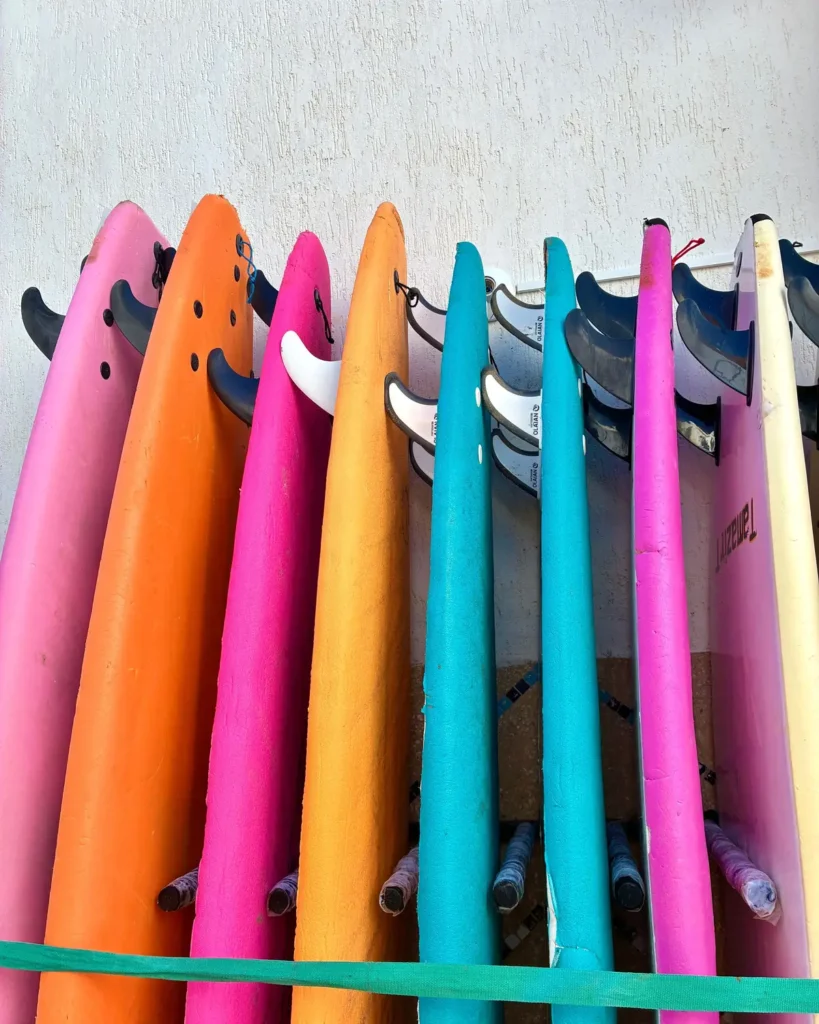 Rental surfboards lined up at a surf shop in Taghazout