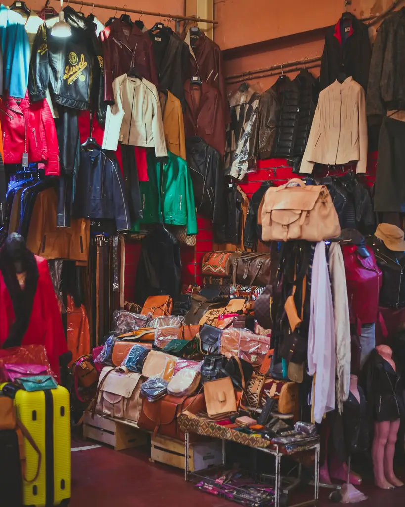 Leather jackets and bags for sale in an indoor Agadir market