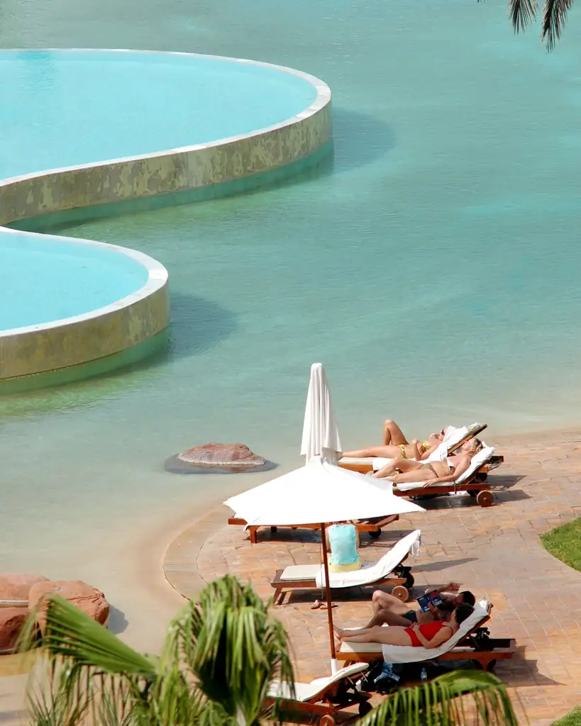 Guests relaxing by a resort pool in Agadir