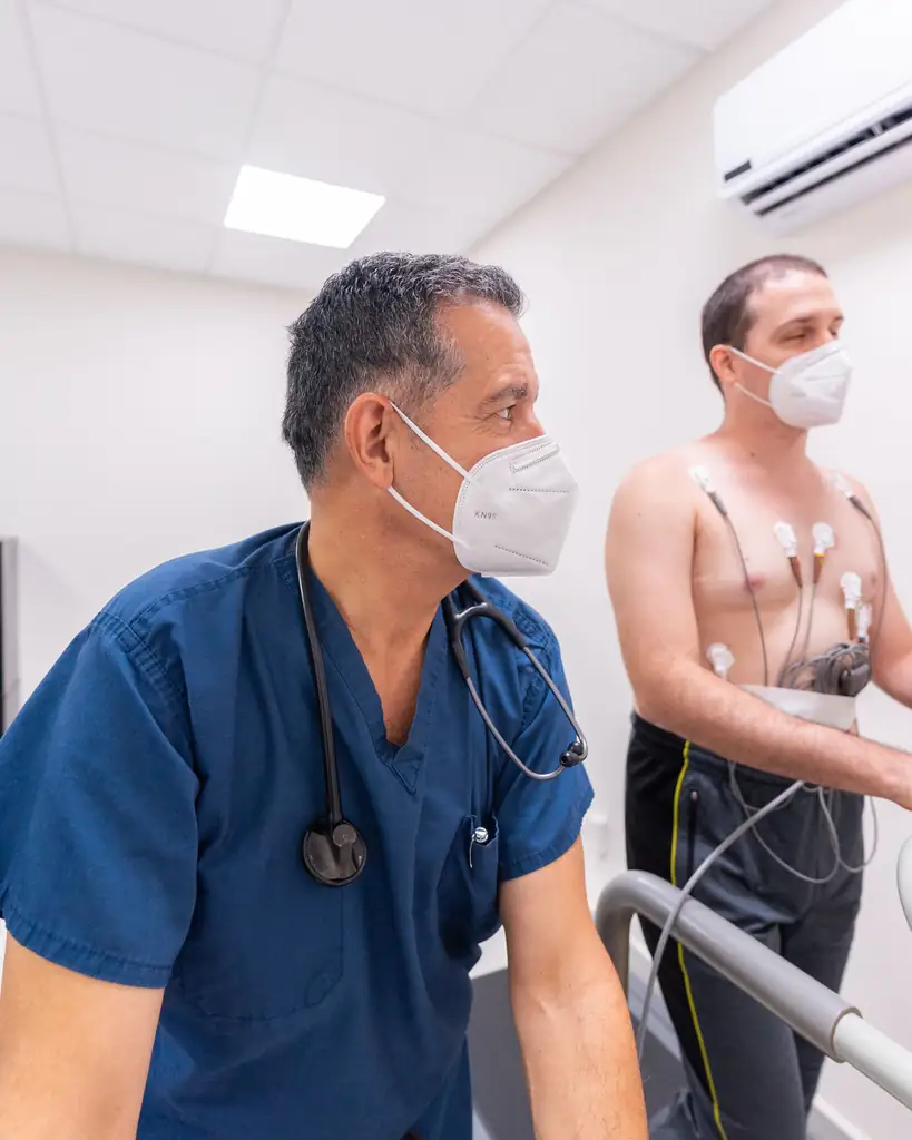 Cardiologist supervising a patient during a cardiac stress test
