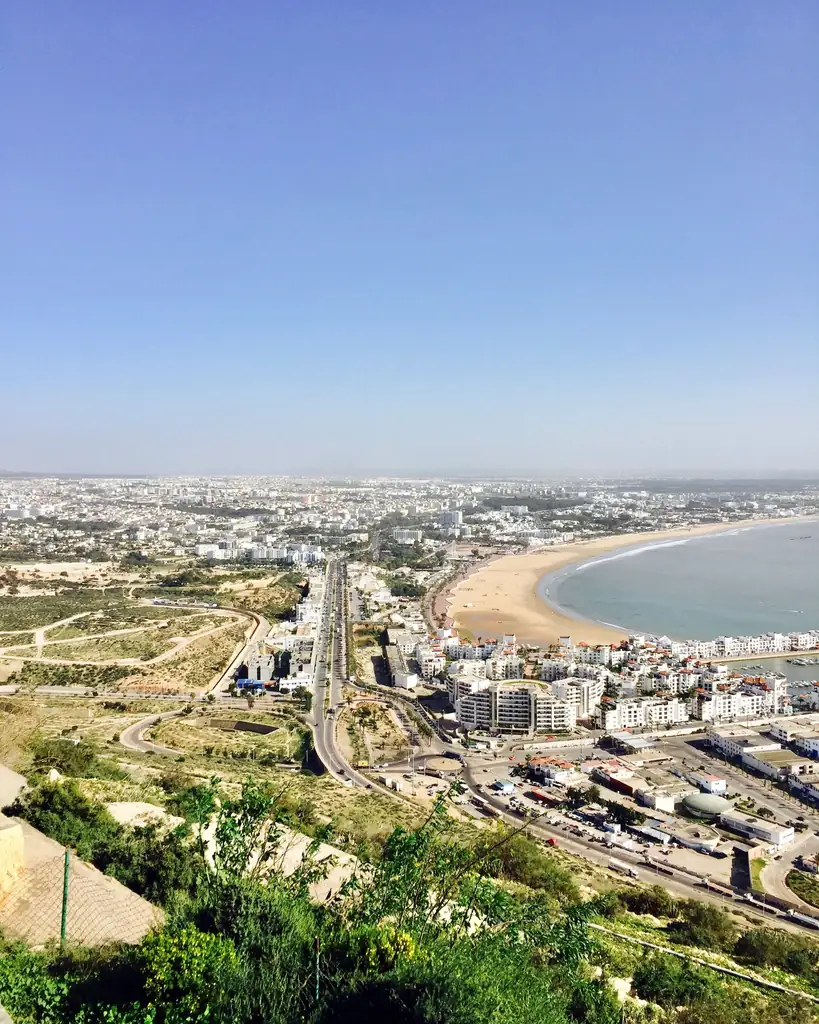 Aerial view of a coastal city bay with residential districts and main roads