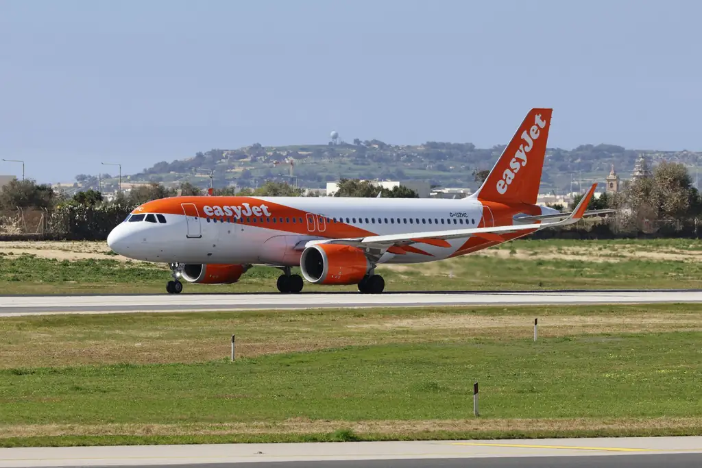 easyJet plane taxiing on the runway with hills in the background