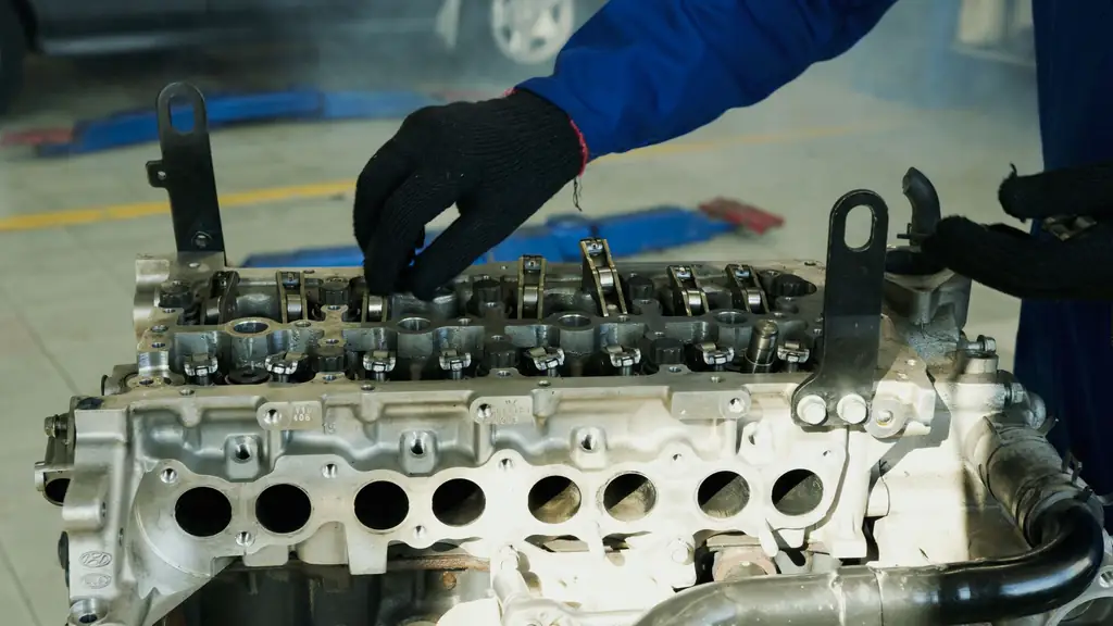 Mechanic working on an engine cylinder head during a repair