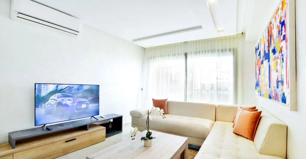 Furnished apartment living room with sofa and TV, the standard of a modern rental