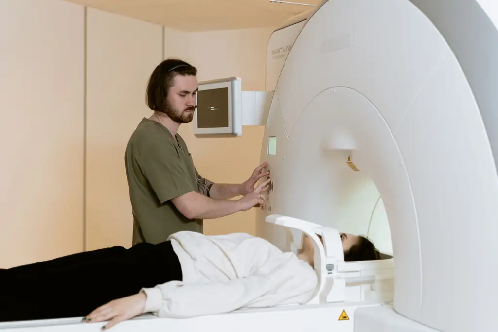 Technician preparing a patient for an MRI scan
