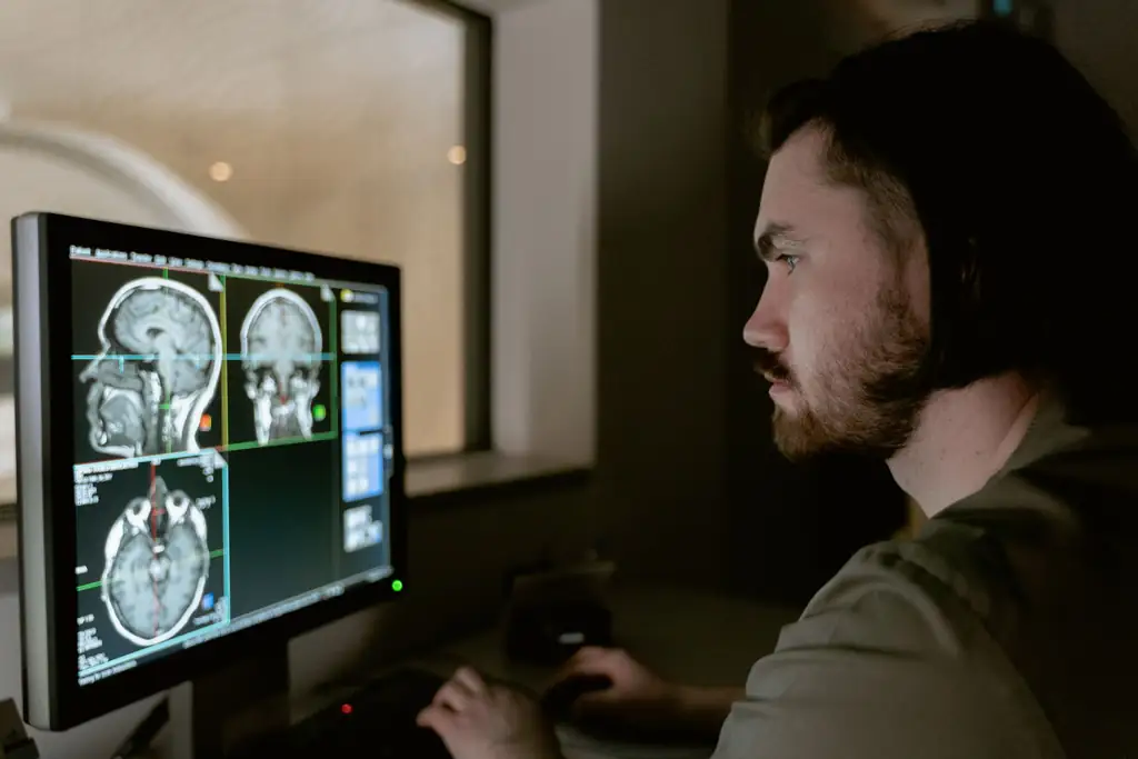 Radiologist reviewing CT scan images on a monitor