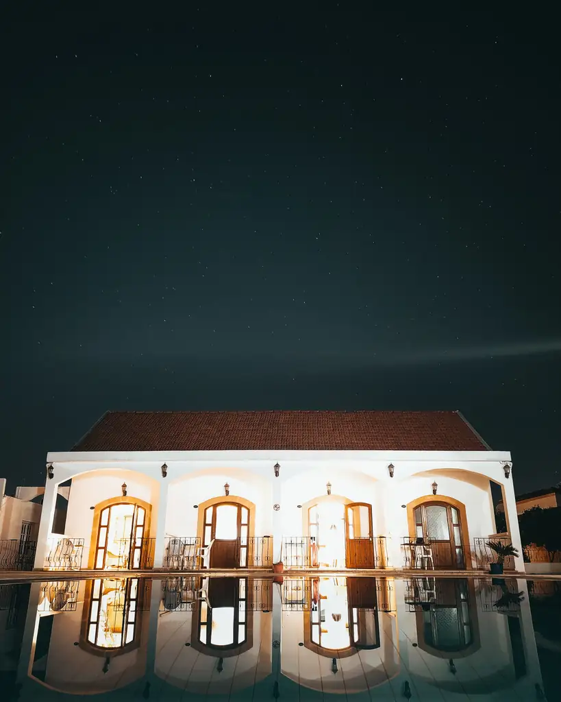 Villa with a private pool lit at night